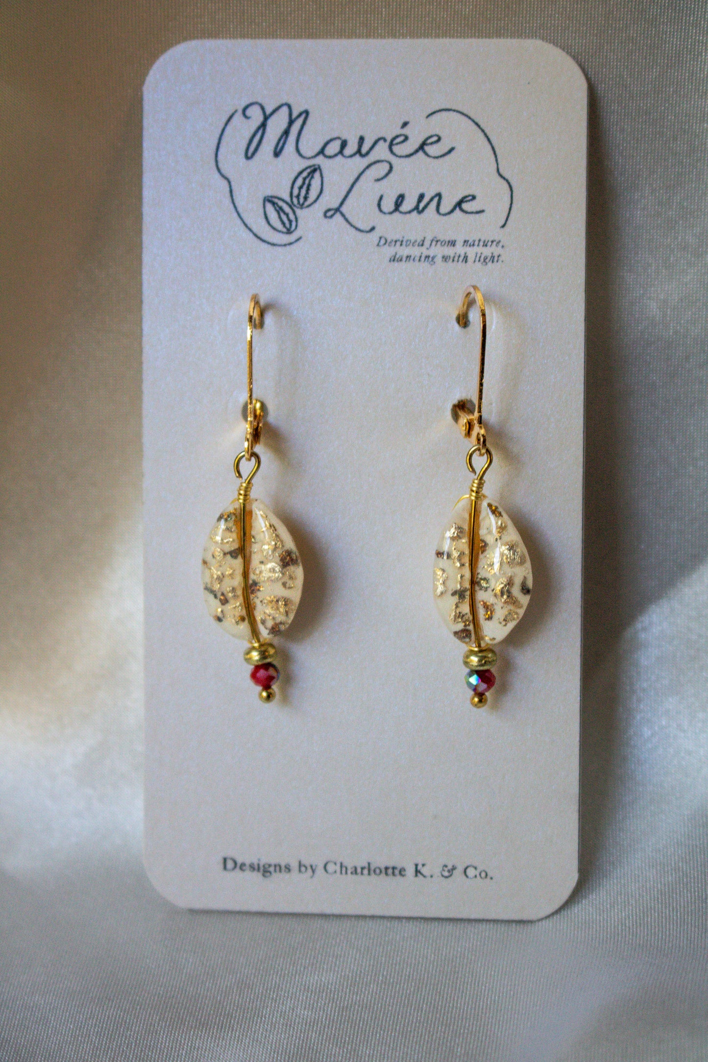 Delicate Fiesta Shell-Studded Earrings featuring hand-gilded cowrie shells and vibrant glass beads, from Mavée Lune.