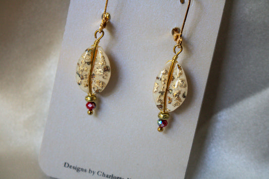 Fiesta Shell-Studded Earrings showcase hand-gilded cowrie shells and colorful beads on gold-plated hooks.