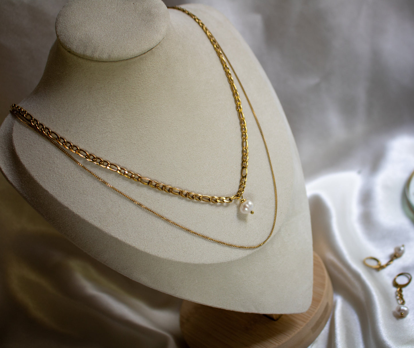 The Drop Necklace showcases 18K gold chains and a luminous freshwater pearl, perfect for layering or solo wear.